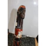 A hardwood carved African walking stick with man's head handle with a Devon and Dorset Regt