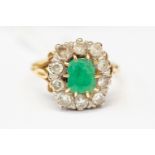 An emerald and diamond cluster ring (emerald af) cushion cut emerald, approx 8mm x 5mm,