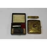 A cased travelling miniature microscope along with a cigarette case and a penknife (3)