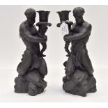 A pair of Wedgwood black basalt stylized Merman figure candlesticks, approx 28.