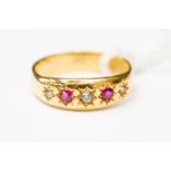 A ruby and diamond ring, star set with two rubies and three small diamonds, 18ct gold mount, size P,