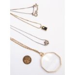 A magnifying glass pendant and chain,