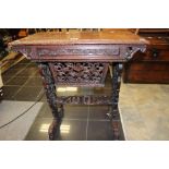 A Chinese hardwood carved work table, moulded edge to top, single drawer with dividers, well below,