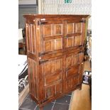 A 20th Century hand crafted joined oak hall cupboard, of two-tier form,