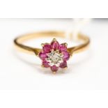 A 9ct gold ruby and diamond flower head cluster ring , size N, total gross weight approx 1.
