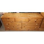 A contemporary pine dresser base, fitted with three drawers over two rows of two longer drawers,