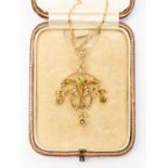 An Edwardian peridot and seed pearl pendant / brooch,