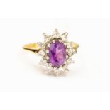 An amethyst and diamond oval cluster ring, 18ct gold mount, size L1/2, total gross weight approx 4.
