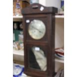 A George V oak cased eight date wall clock,