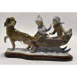 Lladro large figure of two boys in a sleigh being pulled by dog