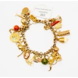 A 9ct gold curb bracelet with various 9ct and 14k gold and unmarked yellow metal charms including