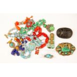 A collection of vintage costume jewellery to include a jet carved scarab beetle,