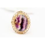 A Blue John set dress ring, the cabochon oval Blue John approx 14mm x 18mm, 9ct gold fancy mount,