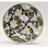 An 18th century tin glazed pottery plate, possibly Lambeth, painted with birds in branches,