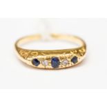 An 18ct gold, diamond and sapphire ring, scroll engraved shoulders, size N1/2,