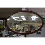 An oval wall hanging Edwardian mirror with inlay around frame,