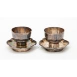 A pair of early 20th Century Chinese egg cups and stands,