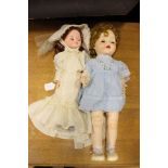 Large celluloid walking and talking doll and another modern doll (2)