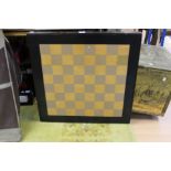 A mid 20th Century chequer topped games table, raised on folding legs,