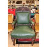 A Victorian Gothic Revival oak armchair, carved crest rail, green upholstered back and seat,
