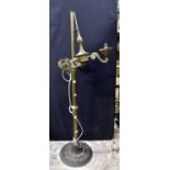 Brass three branch standard lamp with wrought iron base.