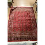 A contemporary machine made Bokhara red ground rug,
