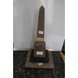 A Derbyshire mixed hardstone obelisk comprising limestone base Ashford marble and granite with