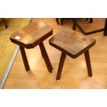 Two elm seated three legged miniature stools,