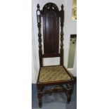 A William and Mary joined oak backstool, the back with a carved crest rail,