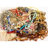 A collection of costume jewellery to include wooden bead necklaces, agate necklace, faux pearls,