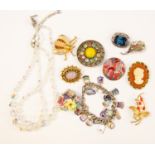A silver charm bracelet with enamelled place charms together with a small quantity of costume