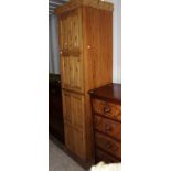 A 20th Century pine tall larder cupboard, with two paenelled doors, 215cm high, 53cm wide,