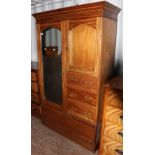 An Edwardian mahogany compactum wardrobe, fitted with a single full length mirrored door,