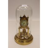 A good German 400 day anniversary clock with a disc pendulum and glass dome, maker is Badische,