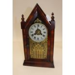 A late 19th early 20th Century American rosewood veneered mantel clock,