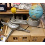 Educational mechanical globe, featuring illuminating sun and revolving earth,