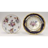 A Royal Crown Derby plate, painted in coloured enamels with a spray of flowers and leaves,