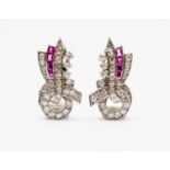 A pair of Art Deco diamond and ruby set clips, the stylised ribbon bow design,