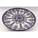 A large HB Quimper dished charger plate in Rouen decor marked P to base for M.