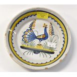 A 19th Century French Faience plate with peacock decoration 20 cm diameter
