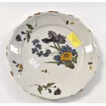 An 18th Century Rouen Faience plate with a floral decoration 22 cm diameter approx