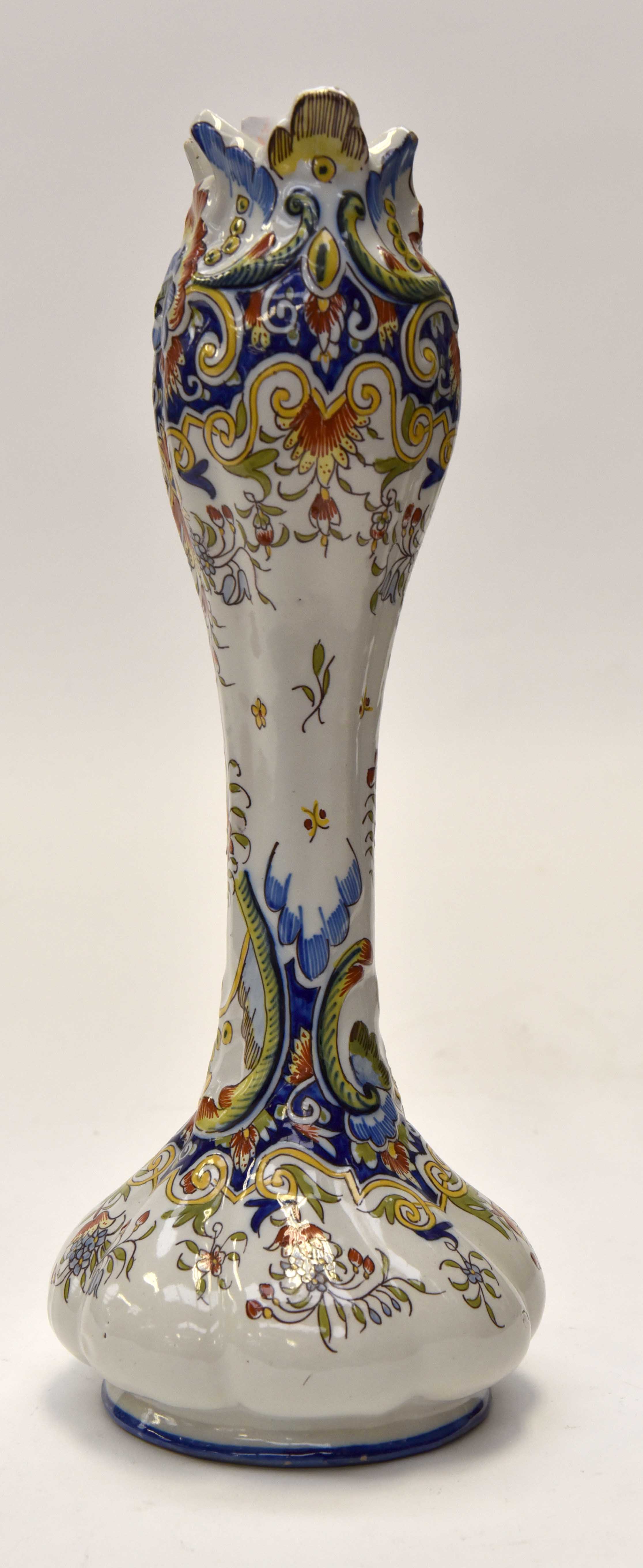 A French Faience Reuen tulip shaped vase, brightly decorated in blue, ocher, green and red,