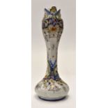 A French Faience Reuen tulip shaped vase, brightly decorated in blue, ocher, green and red,