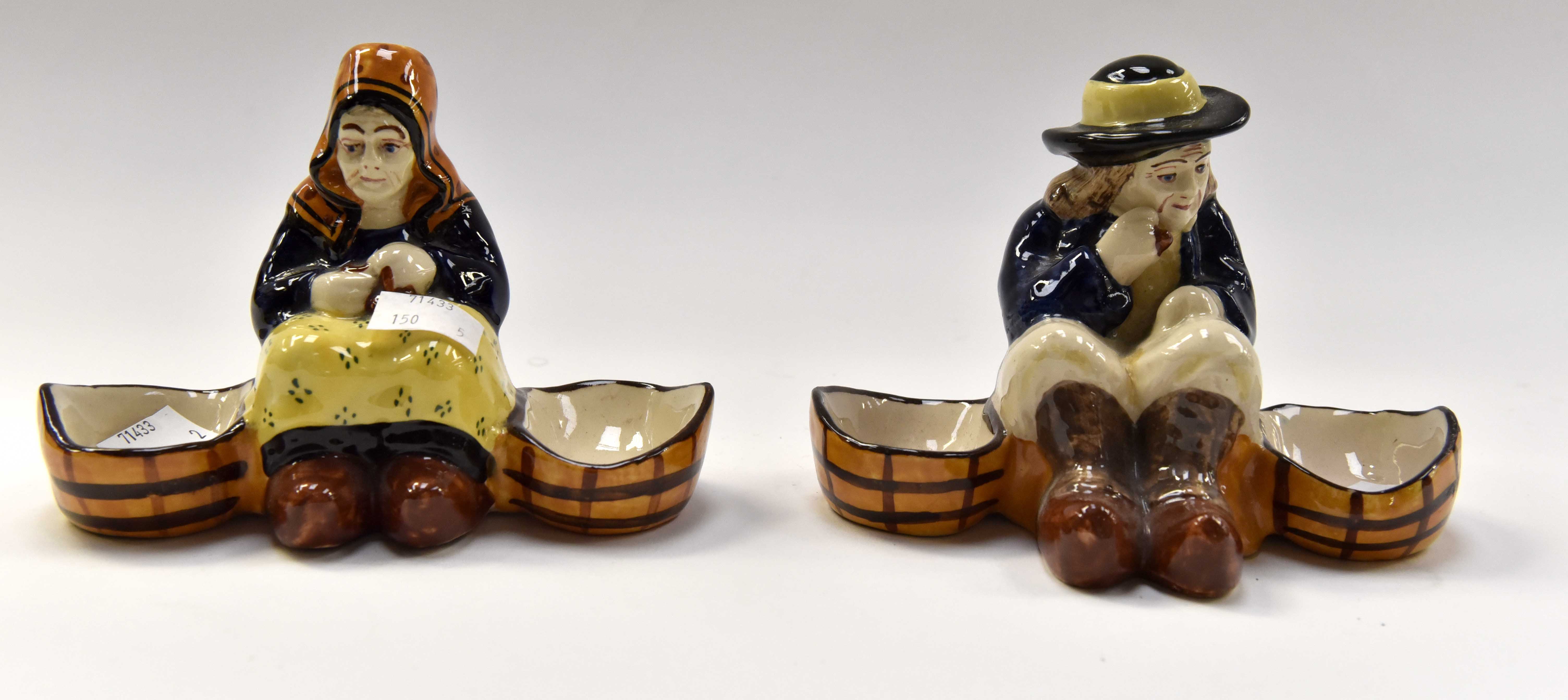 Two H.B. Quimper 19th Century salts. one of seated man, one of seated woman.