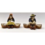 Two H.B. Quimper 19th Century salts. one of seated man, one of seated woman.