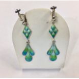 A pair of silver and enamel drop earrings, with blue/ green enamel foliate dropper, diamond shaped