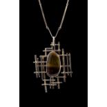 A modernist silver and tiger's eye pendant necklace, the oval cabachon stone approx 2.1cm x 3.7cm,