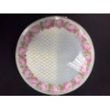 A large round powder box - pale blue enamel to top and sides - border of pink enamel roses to lid.