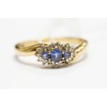 A sapphire and diamond set ring, the three pale blue sapphires set to the top,