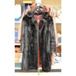 A faux fur dark brown full length coat,